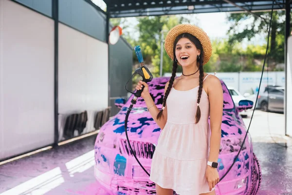 Young Woman High Pressure Hose Stands Front Car Covered Pink — Photo
