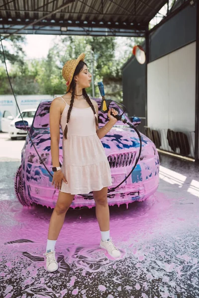 Young Woman High Pressure Hose Stands Front Car Covered Pink — Stock Photo, Image