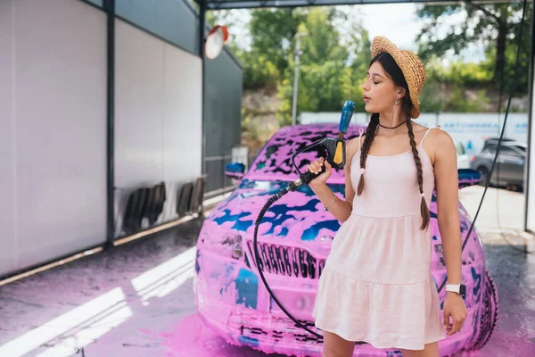 Young Woman High Pressure Hose Stands Front Car Covered Pink — Photo