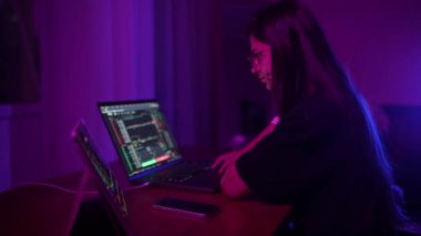 Geceleri evde çalışan çekici genç bir kadın. Dizüstü bilgisayar kullanan kız.