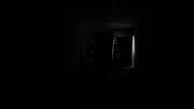 Elinde fener olan genç bir kadın kazıcı tüneli keşfediyor.