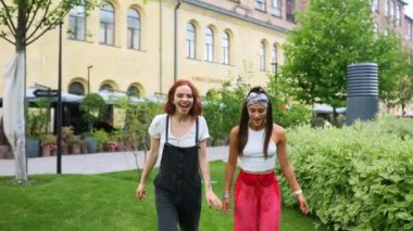 Happy smiling young women have spend time outdoor together. Love couple concept