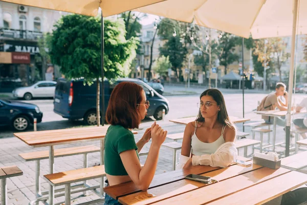 Две Симпатичные Девушки Разговаривают Сидя Баре Городской Улице — стоковое фото