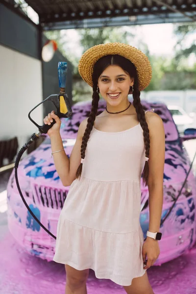 Young Woman High Pressure Hose Stands Front Car Covered Pink — Stock Photo, Image
