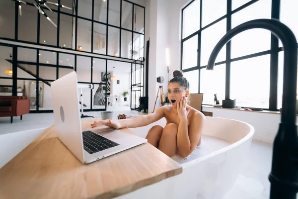 Young Woman Working Laptop While Taking Bathtub Home — Stok fotoğraf