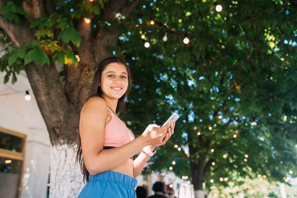 Photo Charming Pretty Young Lady Communicating Modern Gadget Smiling Urban — Stok fotoğraf