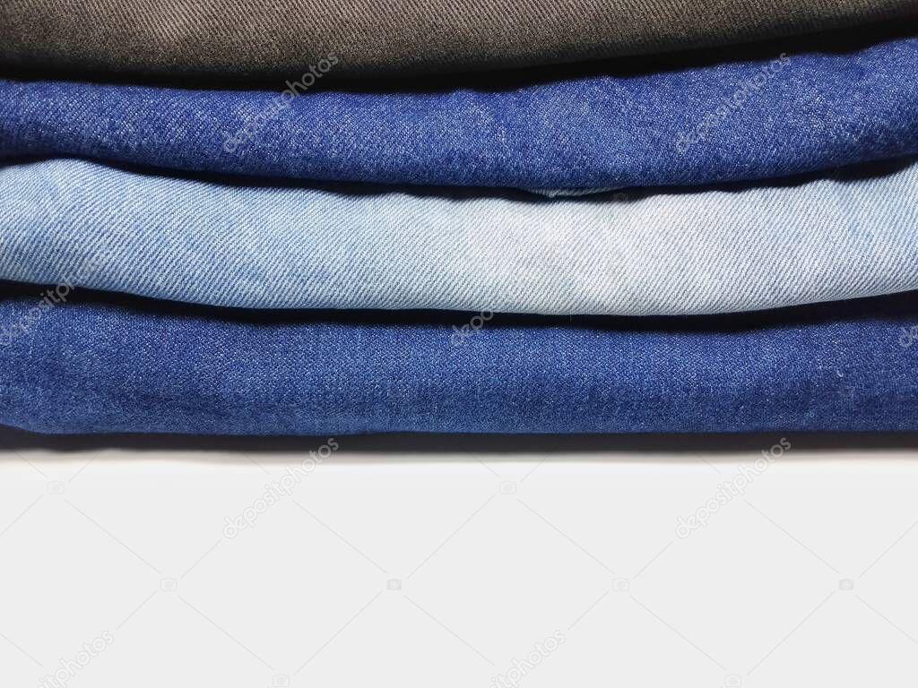 Blue jeans Are neatly folded into layers And white space is copied Use them as backgrounds and wallpapers.