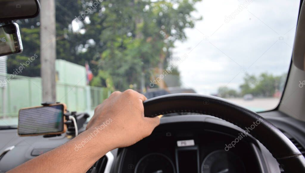hand holding steering wheel, car interior, blurred background, concept, driving, drunk, myopia
