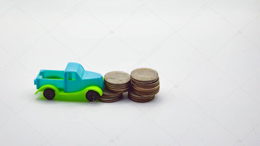 Blue-green pickup truck hit a pile of coins on a white background