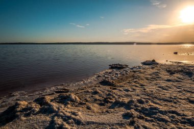 Günbatımında Torrevieja 'nın Salinaları, buharlaşmayla tuz üreten ve içinde yaşayan mikroorganizmalar nedeniyle pembe renkte bir lagün.