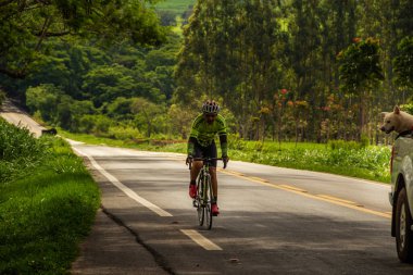 Otoyolda pedal çeviren bir bisikletçi. Gois 'deki GO-462 otoyolunun bir bölümünün manzarası.