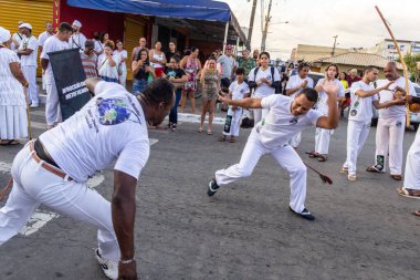 Bir grup insan, Aparecida de Goiania 'daki Yaşlı Siyah Geçit Töreni' nde Capoeira savaşını gösteriyor..