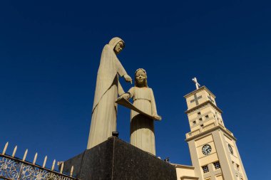 Detail of the Bom Jesus da Lapa Cathedral with an image of a saint and blue sky in the background.