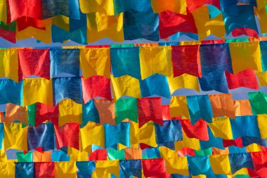 Several clotheslines with fabric flags against the blue sky for june party - typical brazilian festival. 