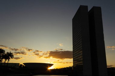 Brasilia Ulusal Kongresi 'nin siluetinde gün batımı öğleden sonra arka planda. Sarımsı tonları olan gökyüzü.