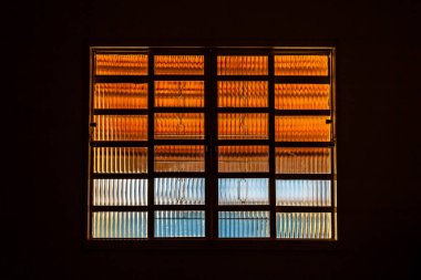  A closed glass window in a dark room. Lighting from the outside.