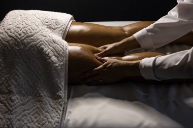 Therapist doing massage to patient. Therapist doing massage on patient's leg.