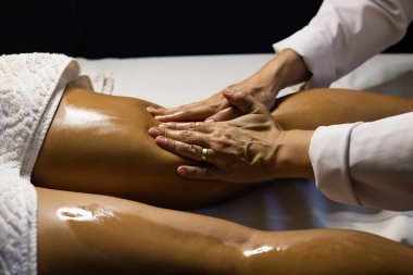 Therapist doing massage to patient. Therapist doing massage on patient's leg.