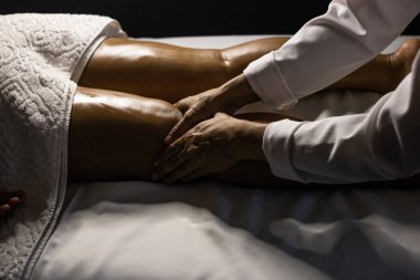 Therapist doing massage to patient. Therapist doing massage on patient's leg.