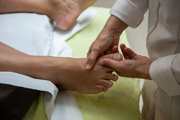 Professional Doing Therapeutic Massage Foot Patient Who Lying Stretcher — Fotografia de Stock