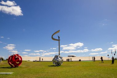 JK Memorial in Brasilia with many tourists, on a clear day with blue sky. An architectural project by Oscar Niemeyer. clipart