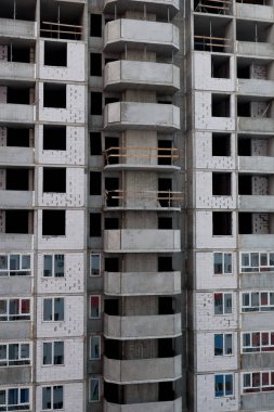 Unfinished residential building. Housing construction, apartment building in the city. Construction site.
