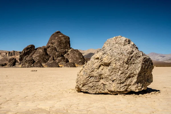 Low Angle of Sailing Stone On The Racetrack Playa With The Grandstand In The Background