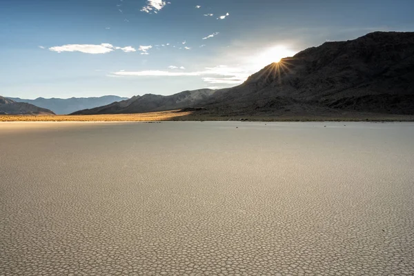 Sun Burst Over The Peaks Above The Dry Lake Bed of Racetrack Playa in Death Valley
