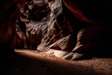 Bright Light Appears to Rush Around Dark Corner of Buckskin Gulch in southern Utah clipart