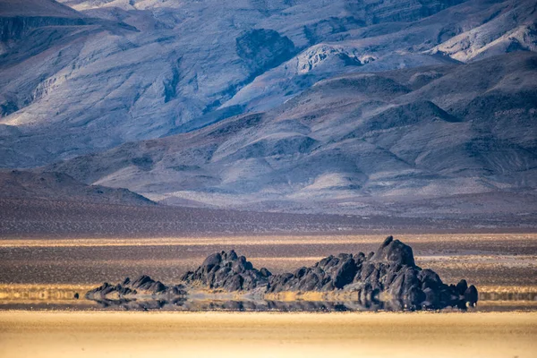 Heat Haze Causes A Reflection Of The Grand Stand On The Racetrack Playa in Death valley