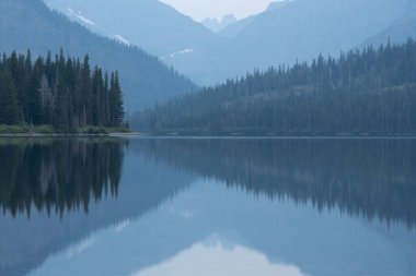 Converging Lines Through A Still Two Medicine Lake in Glacier National Park