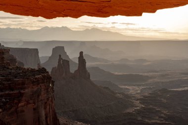 Mesa Arch Overhangs A View of The Washer Woman and The La Sal Mountains in Canyonlands National Park