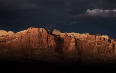 Ominous Dark Clouds Over the Last Light on Cliffs in Capitol Reef National Park