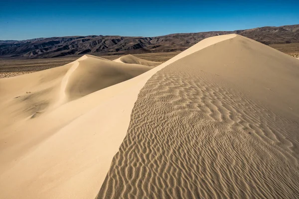 Rippling Texture of Panamint Dunes and Darwin Plateau In The Distance in Death Valley National Park