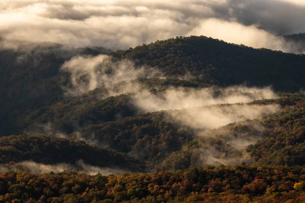 Early Morning Clouds Burn Off Rolling Hills In The Blue Ridge Mountains in North Carolina