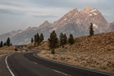 Smooth Curve In The Road Below The Grand Tetons in summer