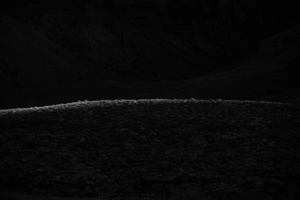 Black and White of Light Cresting On Hill Top in Grand Canyon National Park on the Tonto platform