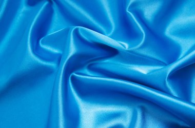 Pürüzsüz mavi ipek arka plan olarak kullanılabilir