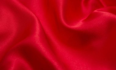 Arkaplan olarak kırmızı saten veya ipek kumaş