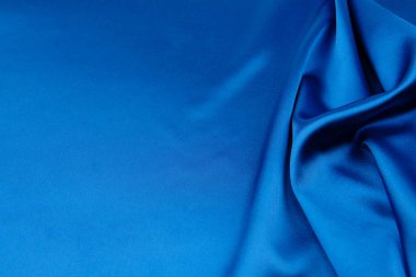 Arkaplan olarak mavi saten veya ipek kumaş