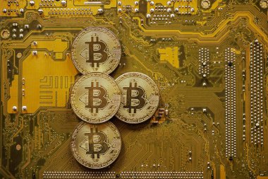 Golden bitcoin on computer motherboard, Bitcoin mining concept