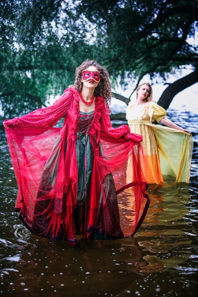 Dramatic Portrait Two Women Historic Gowns Standing Water — Stockfoto