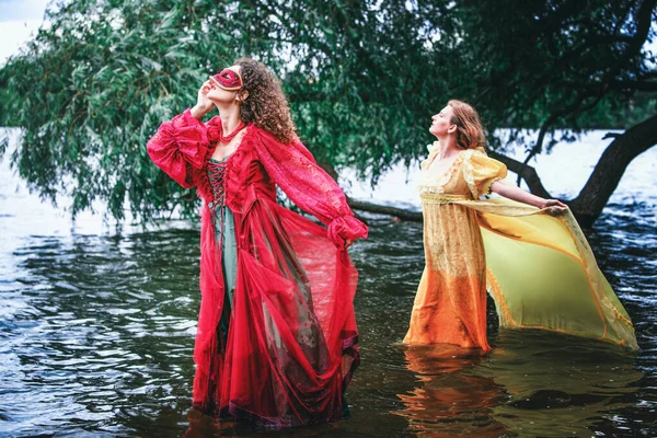 Dramatic Portrait Two Women Historic Gowns Standing Water — Stockfoto