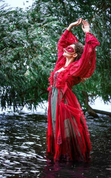 Woman Red Historic Dress Masquerade Standing Water Looking Sky — Stockfoto