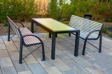 set of table and two modern style benches outdoors
