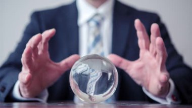 Cinemagraph of a business man looking at a crystal ball