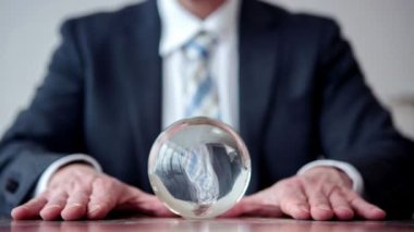 Cinemagraph of a business man looking at a crystal ball