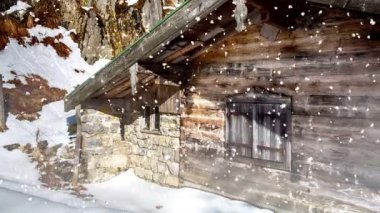 Cinemagraph of wooden cottage in the snow with mountain