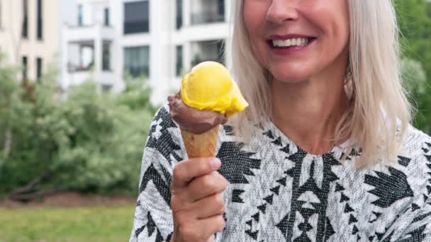 Cinemagraph Blond Woman Eating Ice Cream Outdoors — Vídeos de Stock