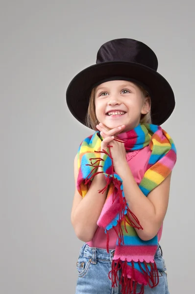 Smiling six year old girl in a black hat — Stock Photo, Image